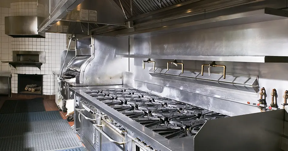 An industrial kitchen focusing on the grill area.